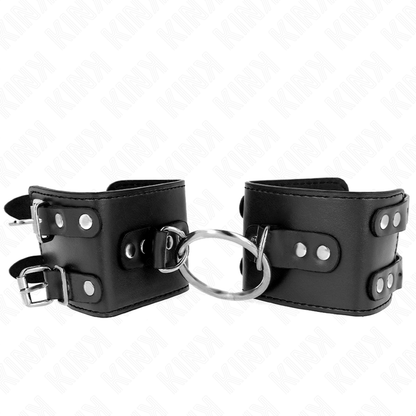 KINK - POLSO FISSO CON ANELLO E BORCHIE REGOLABILE NERO 17-22 CM X 6,5 CM - KINK COLLAR & GAG | Lingerie Harness Boutique