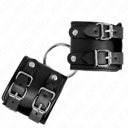 KINK - POLSO FISSO CON ANELLO E BORCHIE REGOLABILE NERO 17-22 CM X 6,5 CM - KINK COLLAR & GAG | Lingerie Harness Boutique